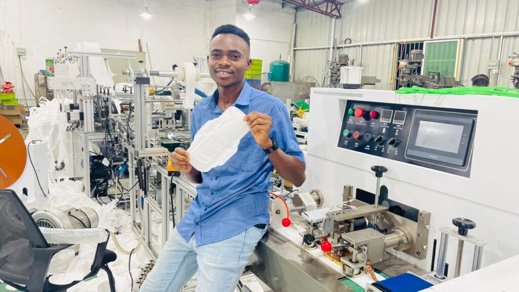 Emadago Oghenekevwe William, Co-founder of Girlified holdigg one of the sanitary napkins made by our high output machine